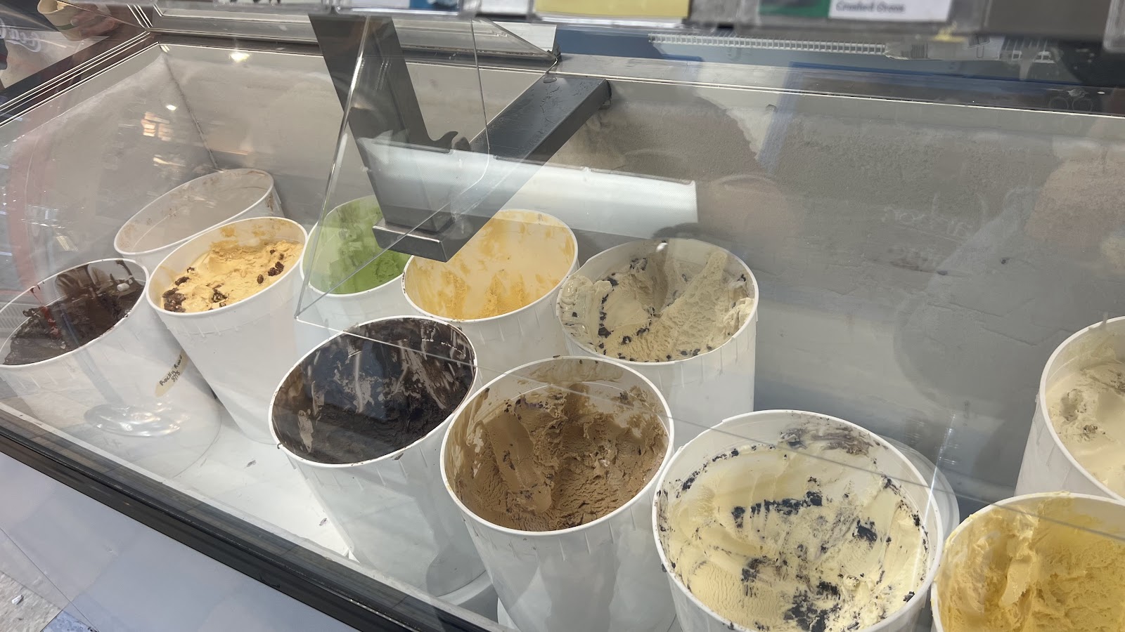 Open tubs of ice cream in the dipping cabinet, from cookies-and-cream to coffee, mango and mint.